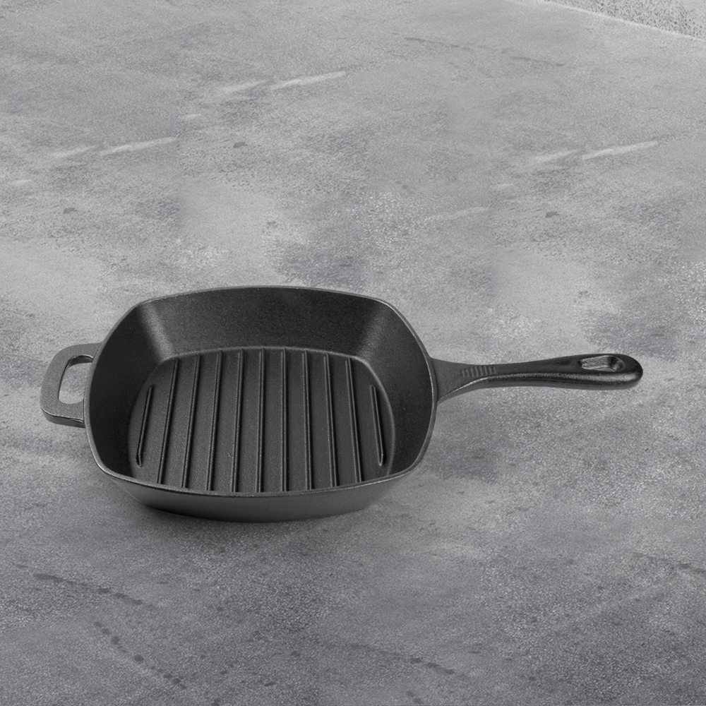 A cast iron square grilling pan with a grain pattern and an auxiliary handle is used for grilling, frying and stir-frying