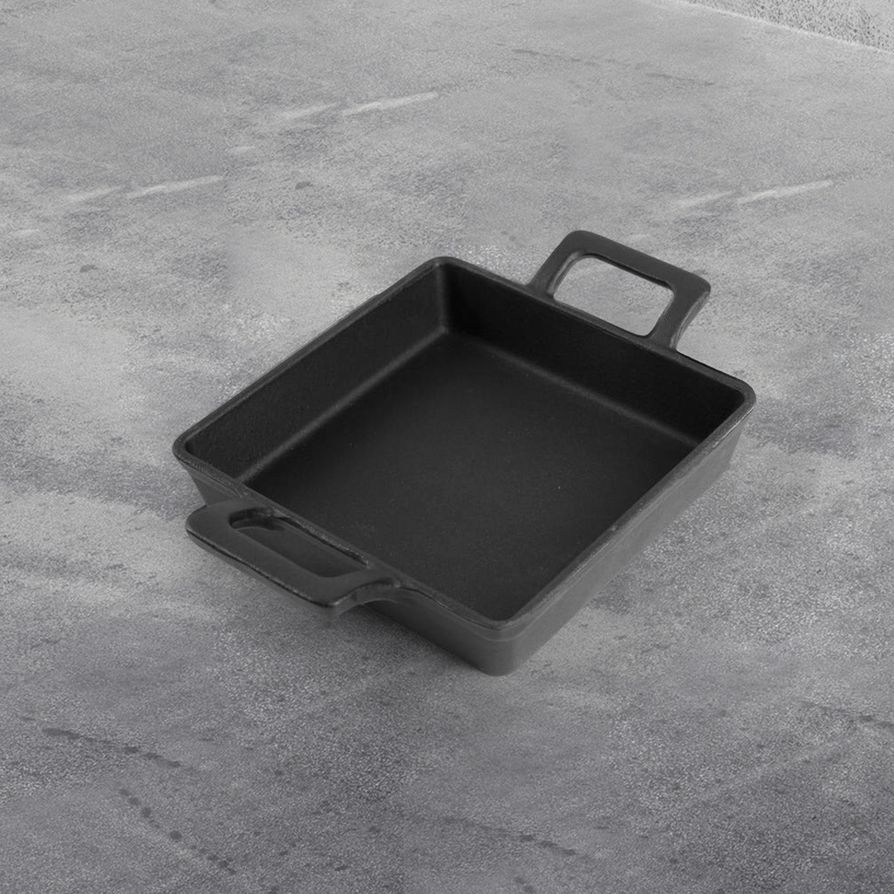 Cast iron mini frying pan with double ears, suitable for both indoor and outdoor use.