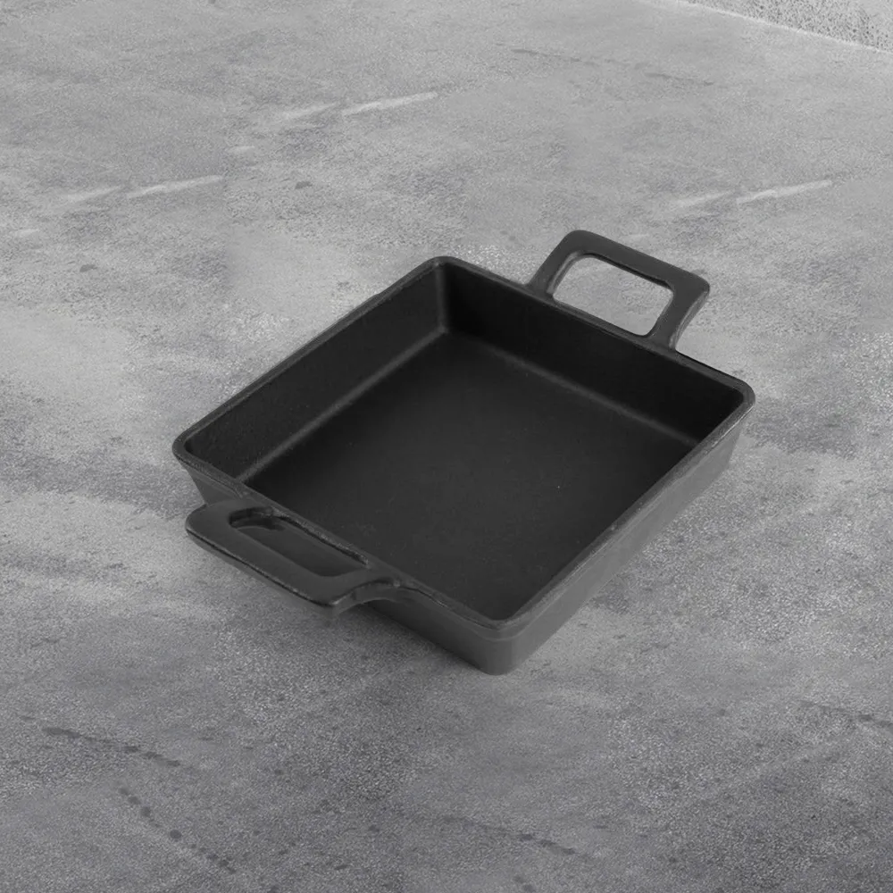 Cast iron mini frying pan with double ears, suitable for both indoor and outdoor use.