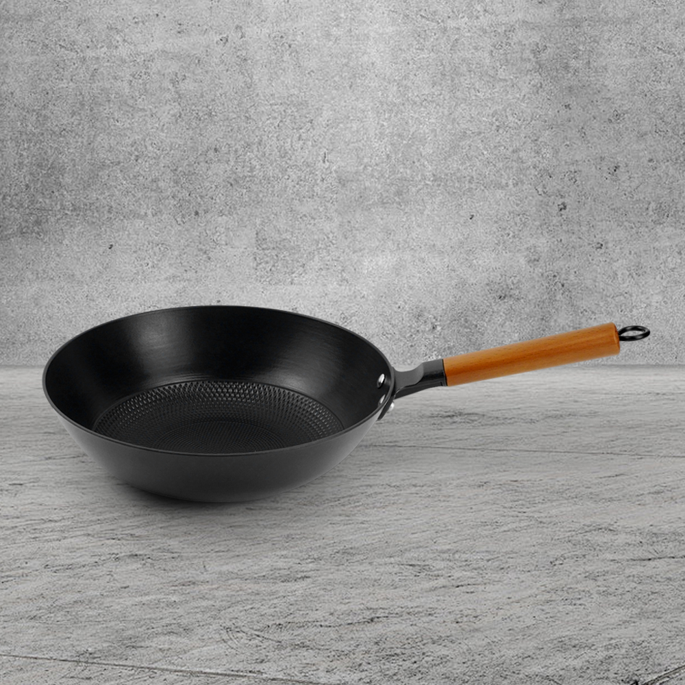 A low-fat, non-stick cast iron wooden-handled wok